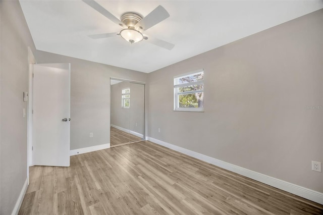 1155 Withlacoochee St, Safety Harbor, FL 34695 - unfurnished bedroom featuring baseboards, ceiling fan, light wood-style floors, and a closet