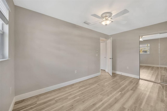 1155 Withlacoochee St, Safety Harbor, FL 34695 - unfurnished bedroom with visible vents, a closet, baseboards, light wood-type flooring, and a ceiling fan