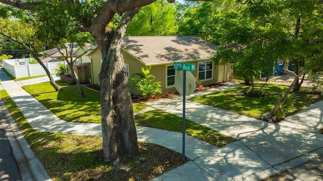 1155 Withlacoochee St, Safety Harbor, FL 34695 - ranch-style home featuring fence, a shingled roof, and a front lawn