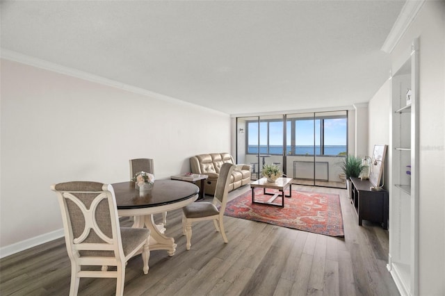 2616 Cove Cay Dr Unit 803, Clearwater, FL 33760 - dining space featuring crown molding, wood finished floors, and baseboards
