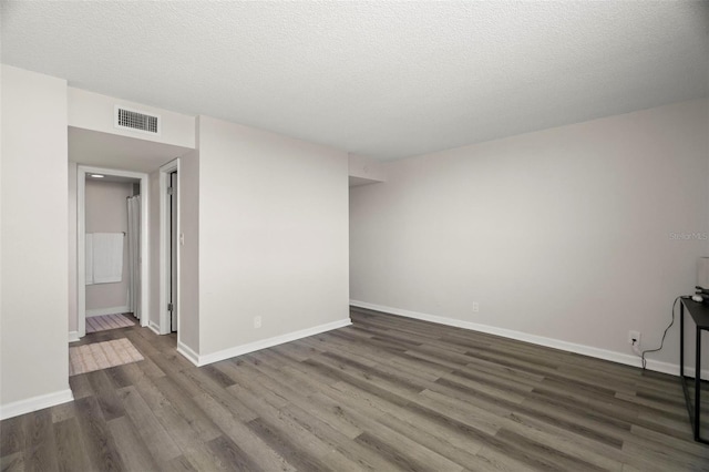 2616 Cove Cay Dr Unit 803, Clearwater, FL 33760 - unfurnished living room with dark wood-style flooring, baseboards, and a textured ceiling