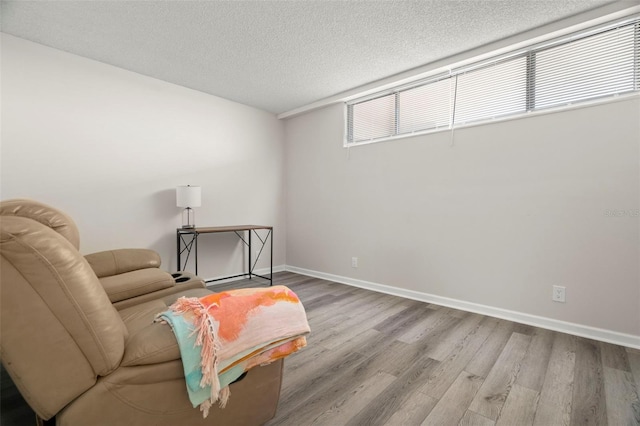 2616 Cove Cay Dr Unit 803, Clearwater, FL 33760 - living area with wood finished floors, a textured ceiling, and baseboards
