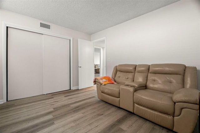 2616 Cove Cay Dr Unit 803, Clearwater, FL 33760 - living area with wood finished floors and a textured ceiling