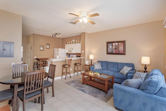 living room with visible vents, light tile patterned floors, ceiling fan, and electric panel