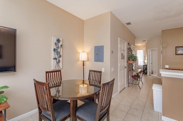 dining area with light tile patterned floors, visible vents, electric panel, and baseboards