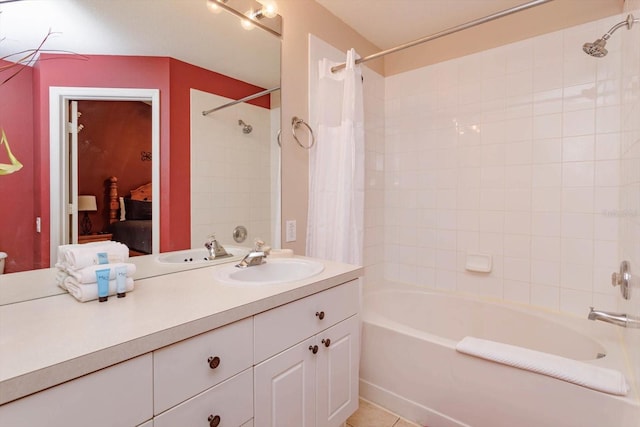 full bathroom with tile patterned floors, shower / tub combo with curtain, ensuite bath, and vanity