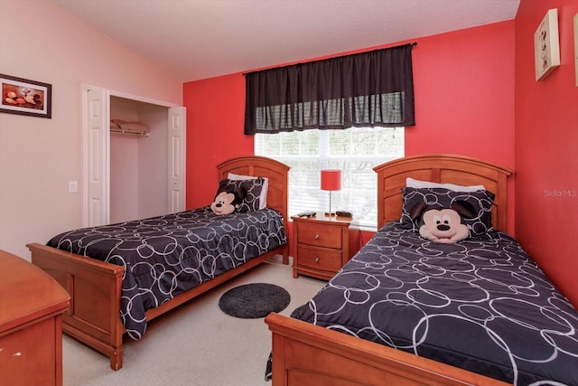 bedroom featuring a closet and light carpet