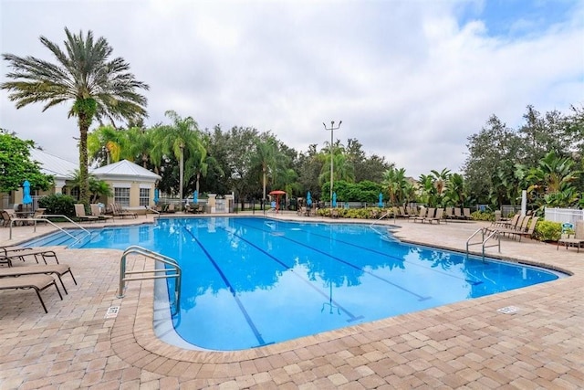 pool featuring a patio and fence