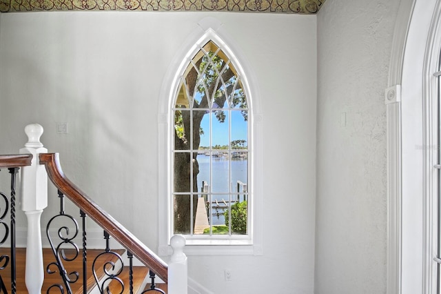 interior details featuring a water view and baseboards