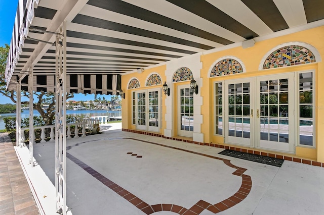 view of patio / terrace with a water view and french doors
