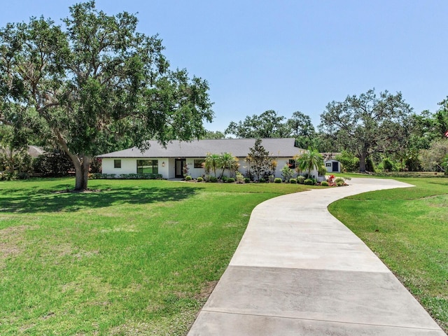 6310 95th St E, Bradenton, FL 34202 - ranch-style house with curved driveway and a front lawn