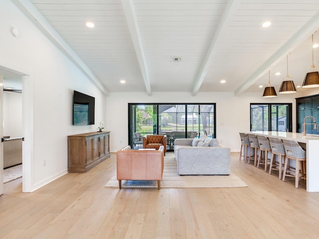 6310 95th St E, Bradenton, FL 34202 - living room featuring visible vents, baseboards, light wood-type flooring, recessed lighting, and lofted ceiling with beams