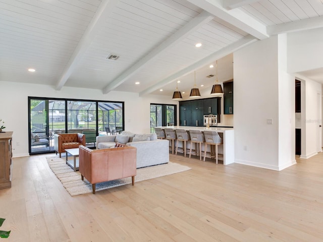 6310 95th St E, Bradenton, FL 34202 - living area with baseboards, vaulted ceiling with beams, light wood finished floors, and visible vents