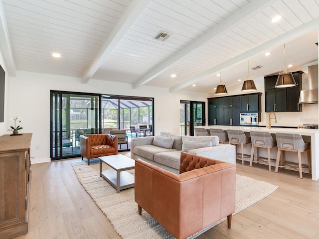 6310 95th St E, Bradenton, FL 34202 - living area featuring visible vents, light wood-style floors, baseboards, and beamed ceiling