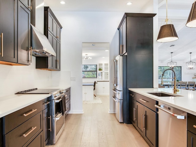 6310 95th St E, Bradenton, FL 34202 - kitchen featuring light countertops, under cabinet range hood, a chandelier, a sink, and stainless steel appliances