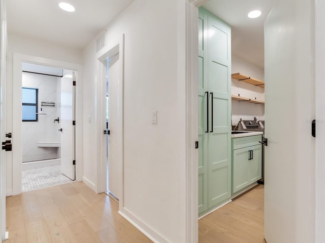 6310 95th St E, Bradenton, FL 34202 - hallway with visible vents, baseboards, recessed lighting, washer and clothes dryer, and light wood-type flooring