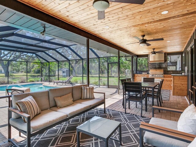 6310 95th St E, Bradenton, FL 34202 - exterior space featuring ceiling fan, outdoor lounge area, an outdoor pool, exterior kitchen, and outdoor dining space