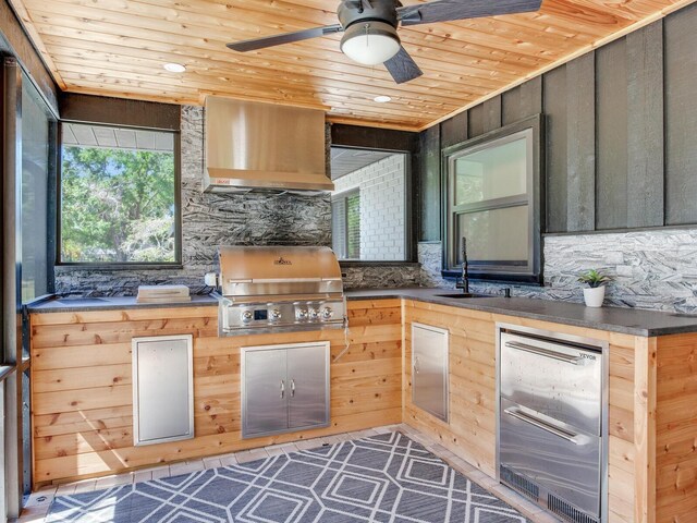 6310 95th St E, Bradenton, FL 34202 - kitchen with stainless steel fridge, wall chimney exhaust hood, wooden ceiling, tasteful backsplash, and a sink