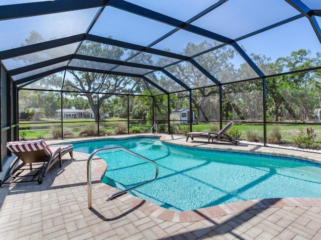 6310 95th St E, Bradenton, FL 34202 - pool with a patio, an outbuilding, glass enclosure, and a storage shed