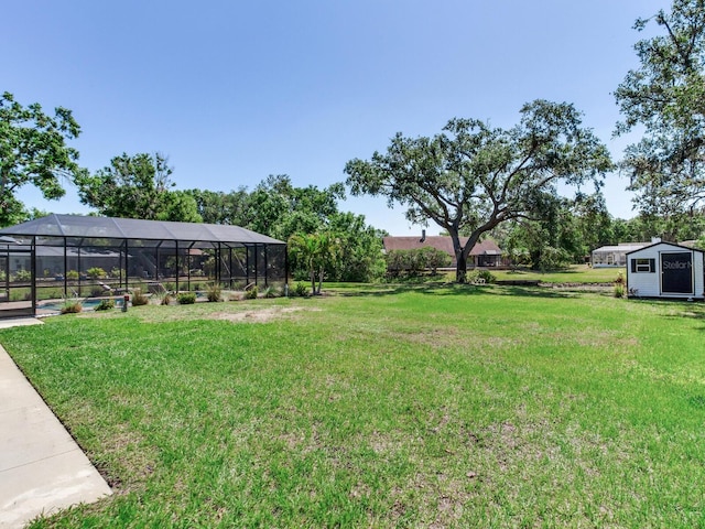 6310 95th St E, Bradenton, FL 34202 - view of yard featuring a storage shed, a swimming pool, an outdoor structure, and glass enclosure