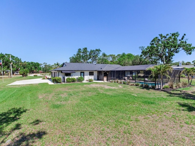 6310 95th St E, Bradenton, FL 34202 - back of property with a lawn, an outdoor pool, and glass enclosure