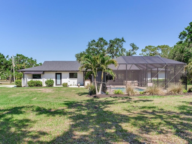 6310 95th St E, Bradenton, FL 34202 - view of front facade with a front lawn, an outdoor pool, and glass enclosure