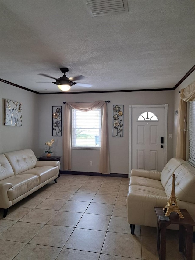 7503 N Howard Ave, Tampa, FL 33604 - living area featuring a ceiling fan, a textured ceiling, visible vents, light tile patterned floors, and ornamental molding