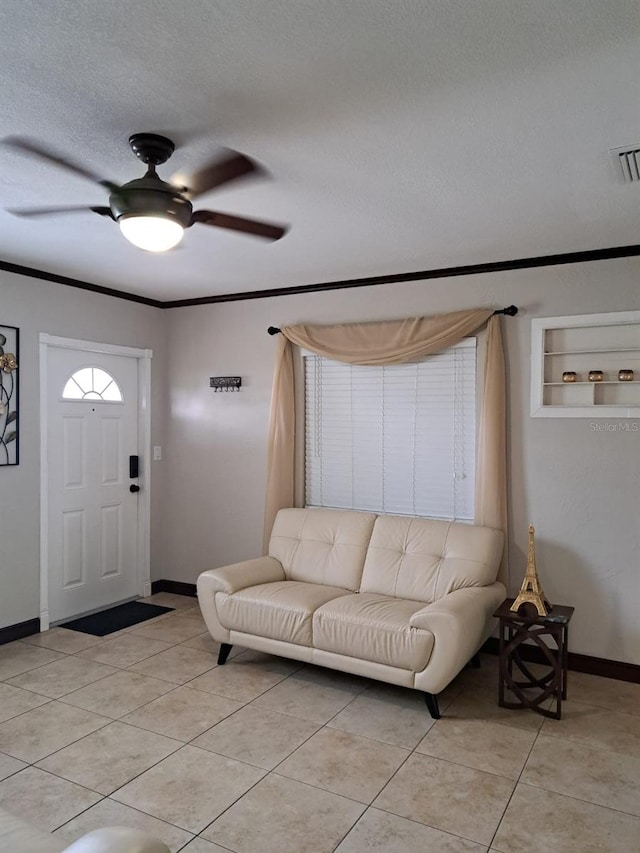 7503 N Howard Ave, Tampa, FL 33604 - living room with ceiling fan, a textured ceiling, visible vents, light tile patterned floors, and baseboards