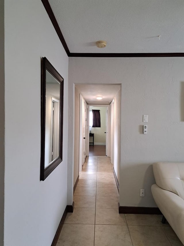7503 N Howard Ave, Tampa, FL 33604 - hall with baseboards, a textured ceiling, crown molding, and light tile patterned floors