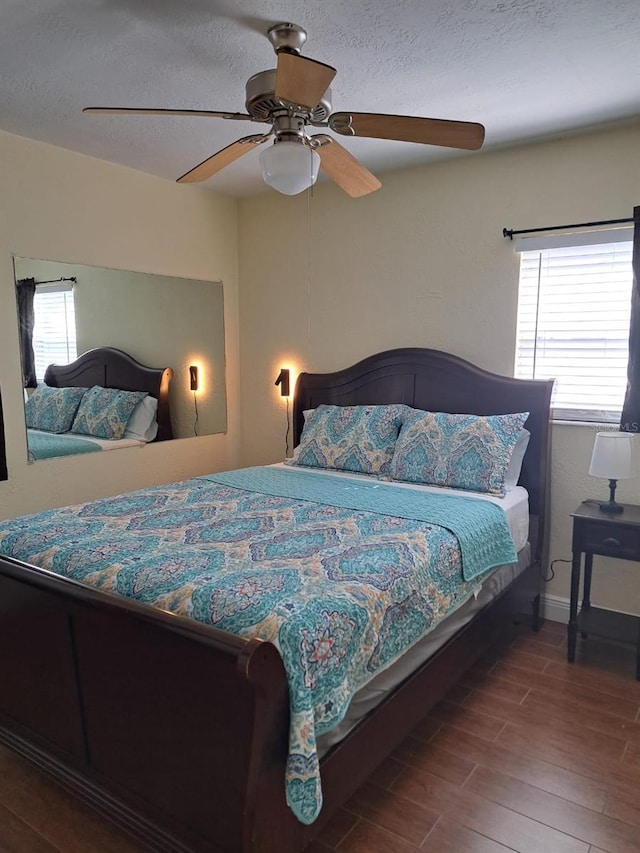 7503 N Howard Ave, Tampa, FL 33604 - bedroom featuring a ceiling fan, a textured ceiling, wood finished floors, and multiple windows