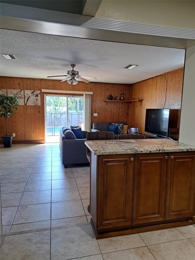 7503 N Howard Ave, Tampa, FL 33604 - kitchen featuring wood walls, a textured ceiling, and visible vents