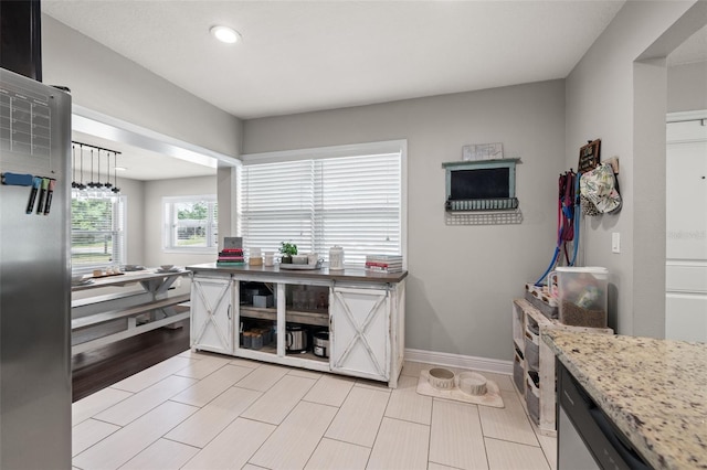 4519 S Grady Ave, Tampa, FL 33611 - kitchen featuring recessed lighting, baseboards, and light stone countertops