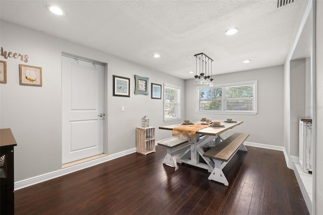 4519 S Grady Ave, Tampa, FL 33611 - dining space with baseboards, dark wood-style flooring, recessed lighting, a textured ceiling, and a chandelier