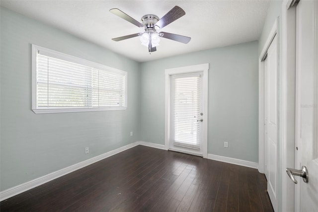 4519 S Grady Ave, Tampa, FL 33611 - unfurnished room with baseboards, a ceiling fan, and dark wood-style flooring