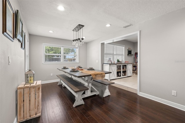 4519 S Grady Ave, Tampa, FL 33611 - dining area with baseboards, a textured ceiling, wood finished floors, recessed lighting, and a chandelier