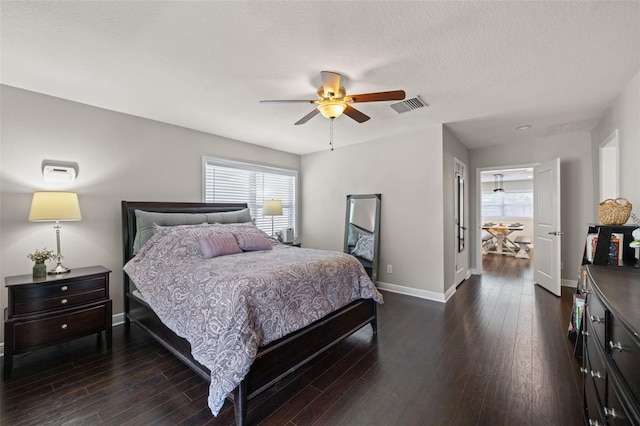 4519 S Grady Ave, Tampa, FL 33611 - bedroom with baseboards, multiple windows, dark wood finished floors, and a ceiling fan