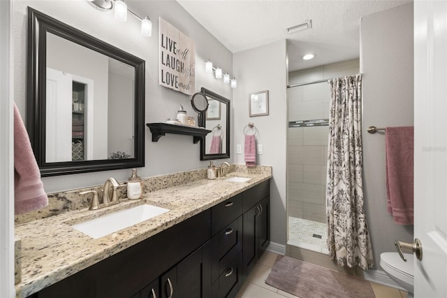 4519 S Grady Ave, Tampa, FL 33611 - bathroom with double vanity, a tile shower, toilet, tile patterned floors, and recessed lighting