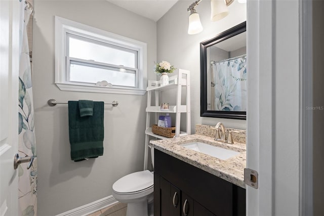 4519 S Grady Ave, Tampa, FL 33611 - full bathroom featuring vanity, toilet, and baseboards