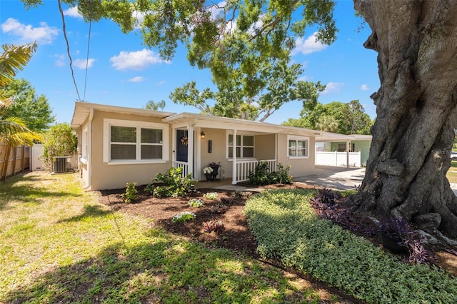 4519 S Grady Ave, Tampa, FL 33611 - ranch-style house featuring central AC unit, covered porch, and stucco siding