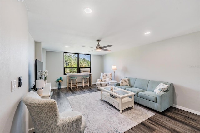 living room featuring baseboards, a ceiling fan, wood finished floors, and recessed lighting