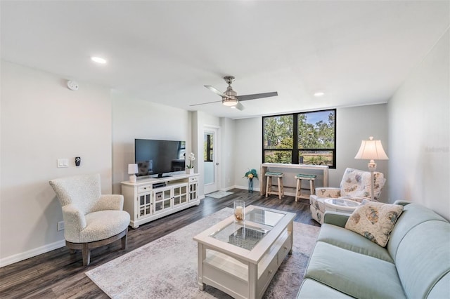living area featuring recessed lighting, wood finished floors, and baseboards
