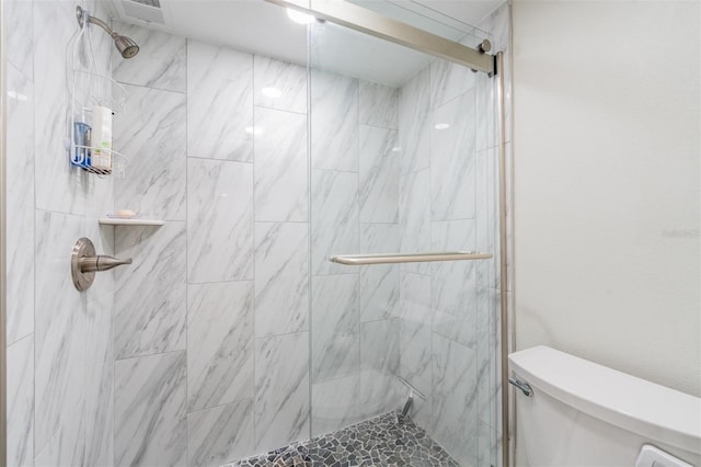 full bath featuring visible vents, toilet, and a stall shower