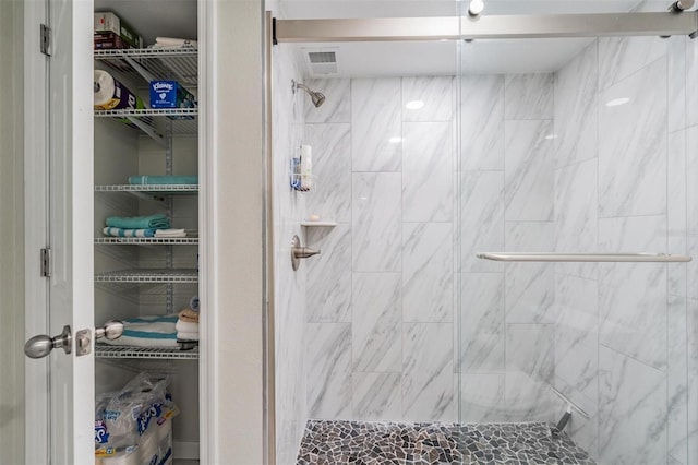 bathroom featuring visible vents and a stall shower