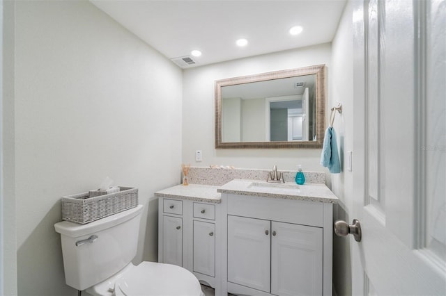 bathroom featuring visible vents, vanity, and toilet