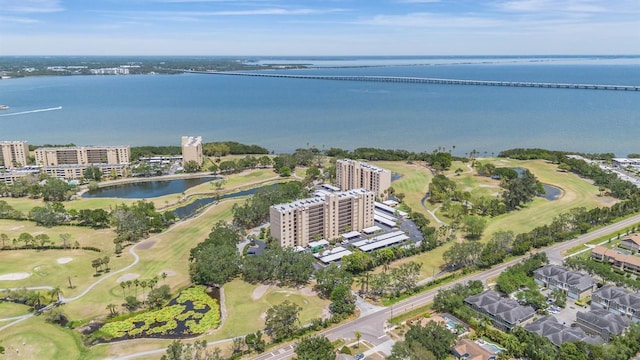drone / aerial view featuring view of golf course and a water view