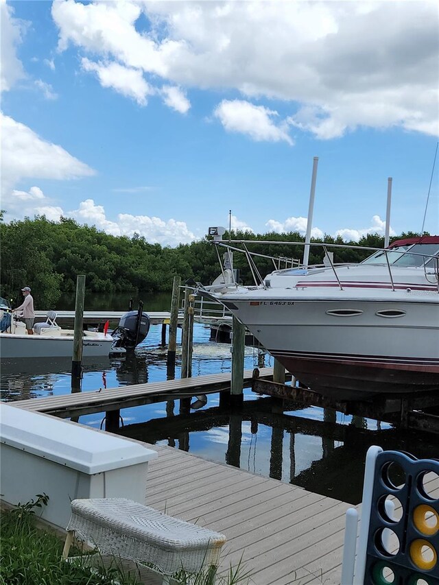 view of dock with boat lift and a water view