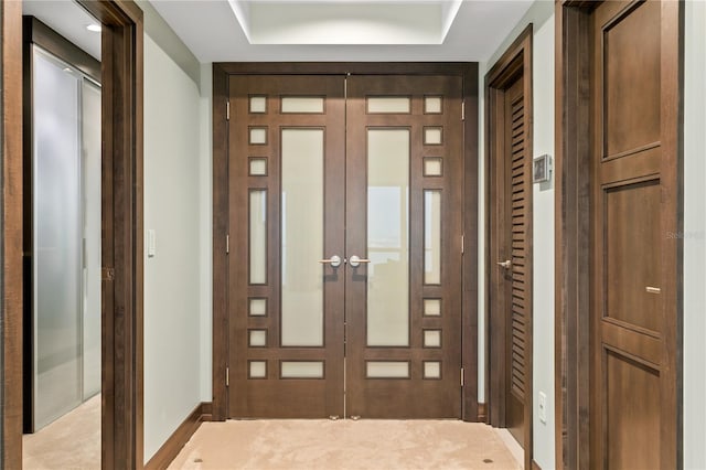 hallway with baseboards and french doors