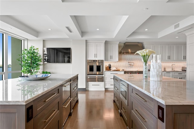 3301 Bayshore Blvd Unit 2401E, Tampa, FL 33629 - kitchen with appliances with stainless steel finishes, a raised ceiling, a large island, visible vents, and a warming drawer