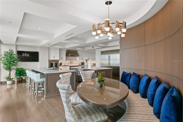 3301 Bayshore Blvd Unit 2401E, Tampa, FL 33629 - dining area with beamed ceiling, a notable chandelier, coffered ceiling, recessed lighting, and light wood-style flooring