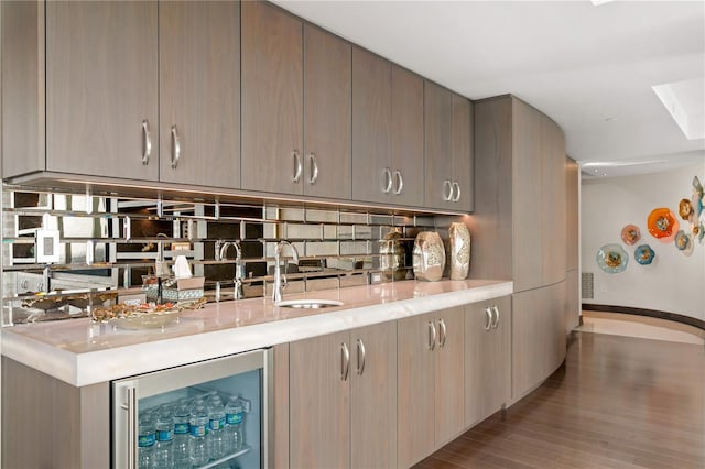 3301 Bayshore Blvd Unit 2401E, Tampa, FL 33629 - bar with bar, decorative backsplash, wood finished floors, a sink, and beverage cooler